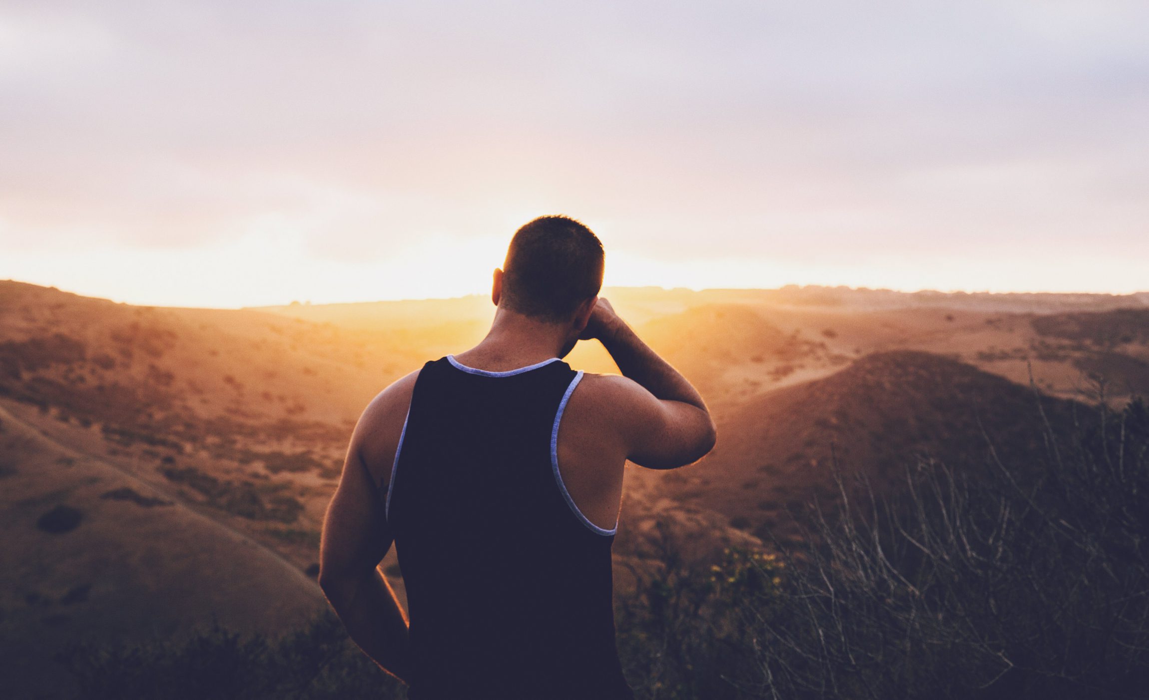 strong man overseas watching sunset