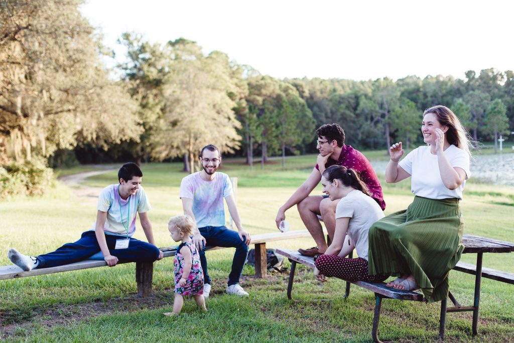men and women students sitting on the campus near the lake at ywam orlando
