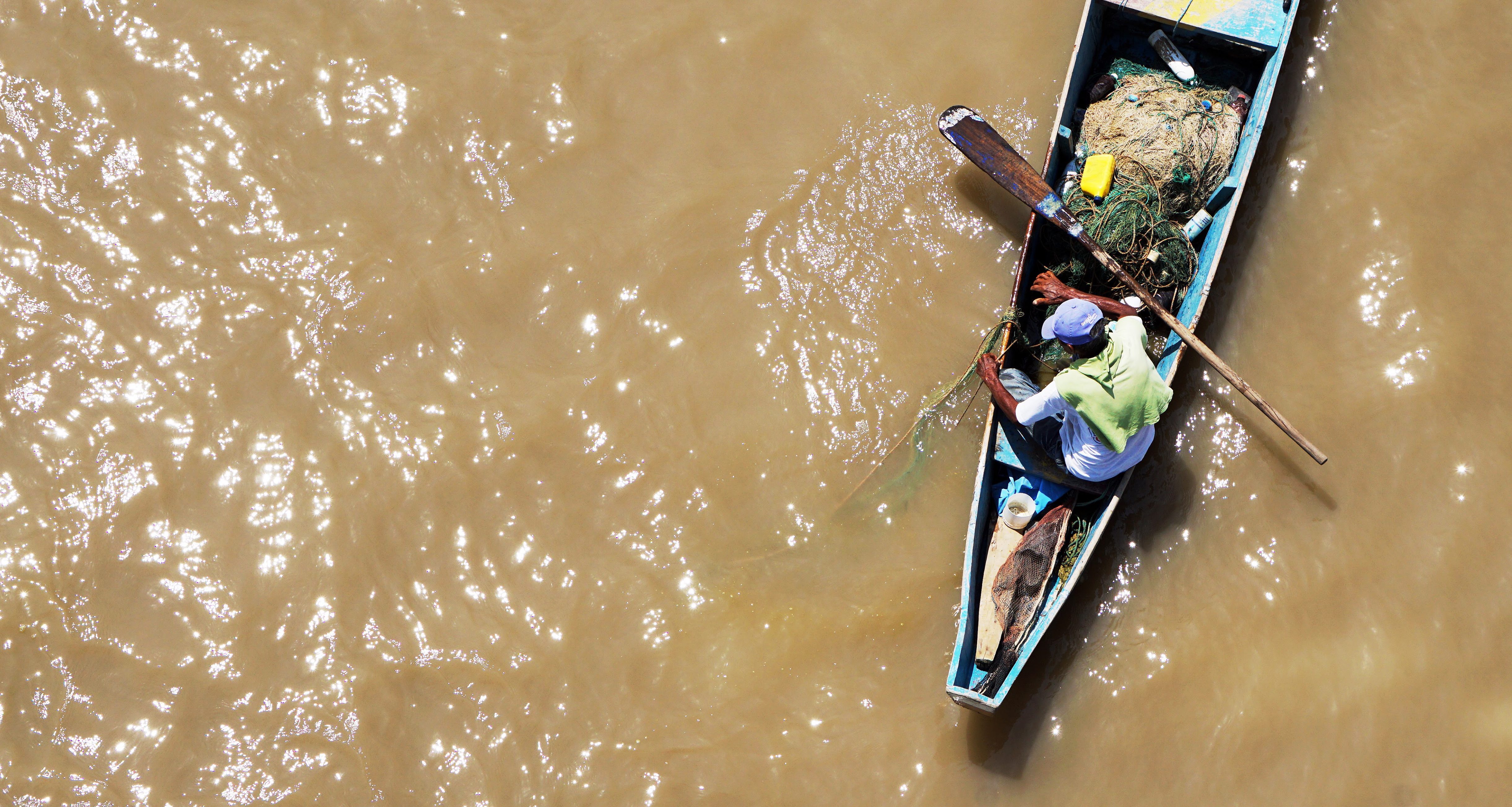 fisherman in muddy water