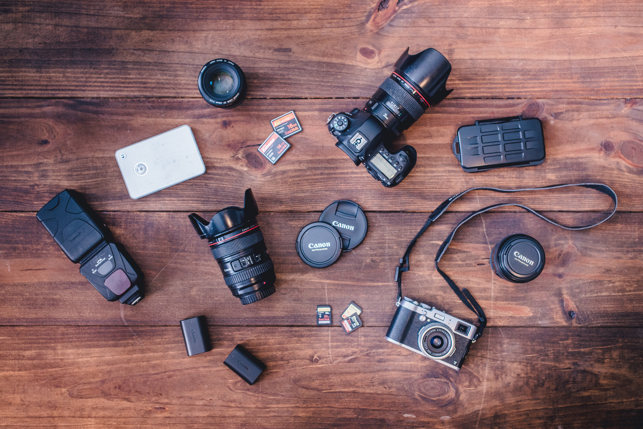 A variety of cameras, lenses, batteries, flashes, and memory cards